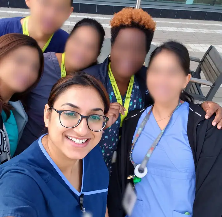 Jasraj taking a selfie with fellow nurses wearing RN Proud lanyards